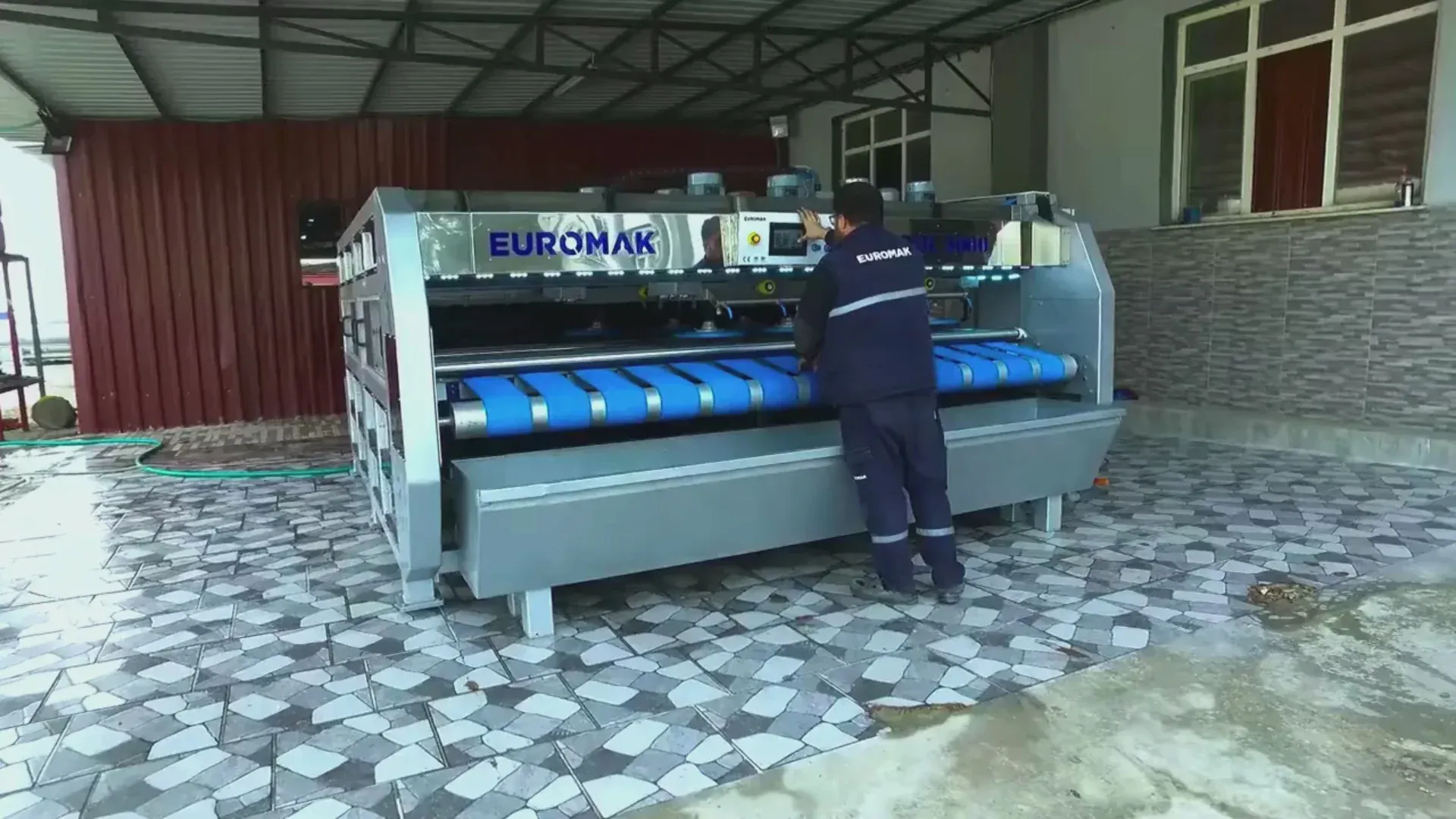 Area rug hanging on drying rack at cleaning facility